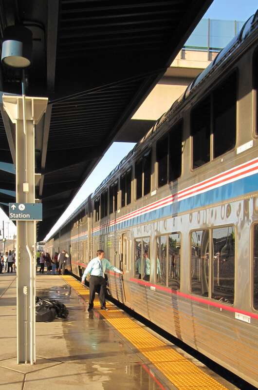 A car attendent checks the doors of an Amtrak SuperLiner car at Denver Union Station as the evening California Zephyr prepares to depart.