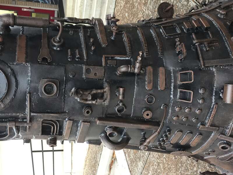 Close up details. Tree of Good and Evil, painted steel and bronze sculpture by artist Charles Pilkey, on public display behind the Arts Council of Fayetteville, on Hay Street in downtown Fayetteville NC.