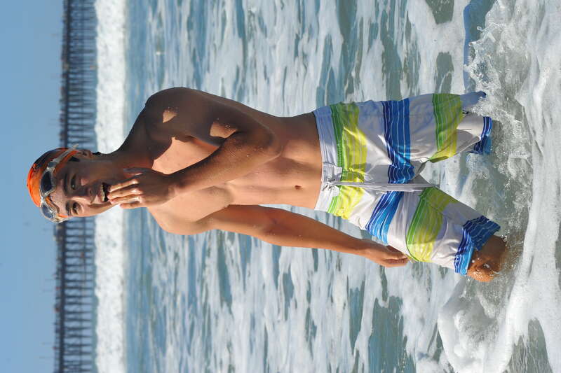A young swimmer emerges from the water with little care for his swim time. He seems happy just to have completed the swim around the pier in trying conditions.

NCB_5599_cr