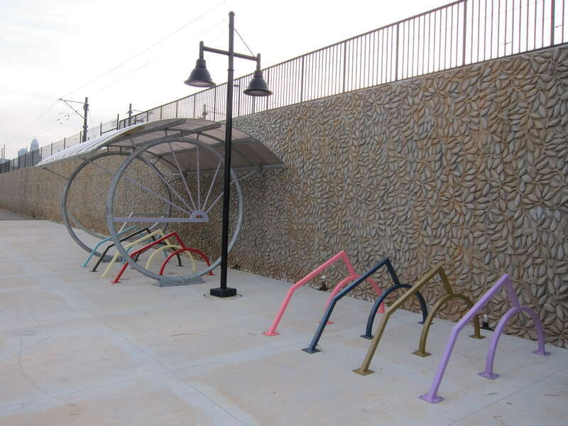 Designed by Darren Goins, these unique bike rack and shelter, using geometric abstract shapes, are found at every station along the LYNX Blue Line Extension (image shown is at 25th Street Station).