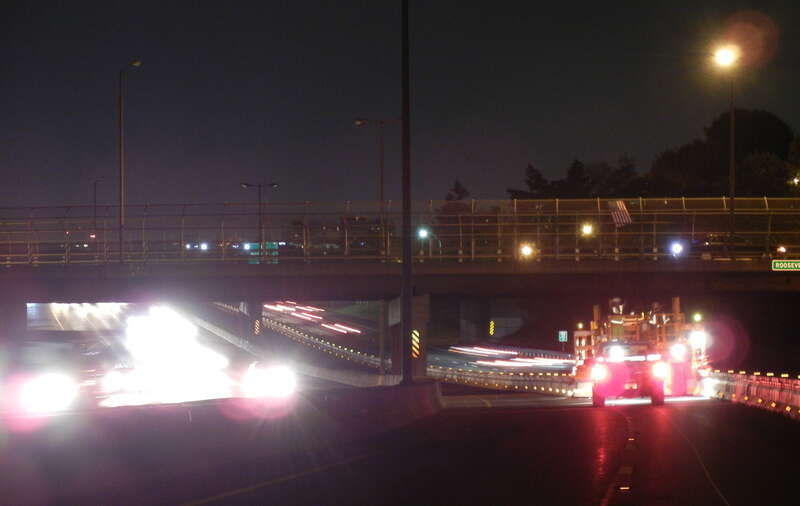This photo shows the &quot;zipper&quot; truck moving a barrier into place on May 6, 2011 while traffic flows freely on both sides of I-93.. 
The zipper barrier will be used to provide a safe crossover for traffic during weekends this summer when MassDOT will