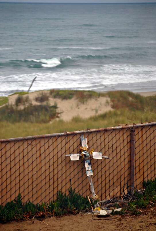a make shift cross at surf Amtrak Station in remembrance of  a surfer killed here   Shark kills Surfer  One of a series of photos taken from the Pacific Surfliner at Surf Amtrak station in California