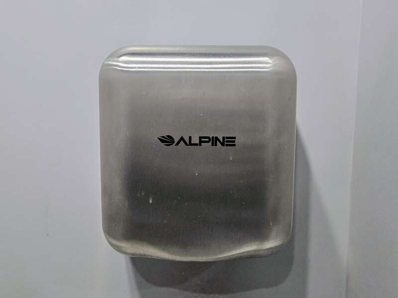 An Alpine Hemlock jet hand dryer in stainless steel in a restroom in Alexandria VA. The Hemlocks are made by a Chinese company called KINGWE for Alpine Industries.