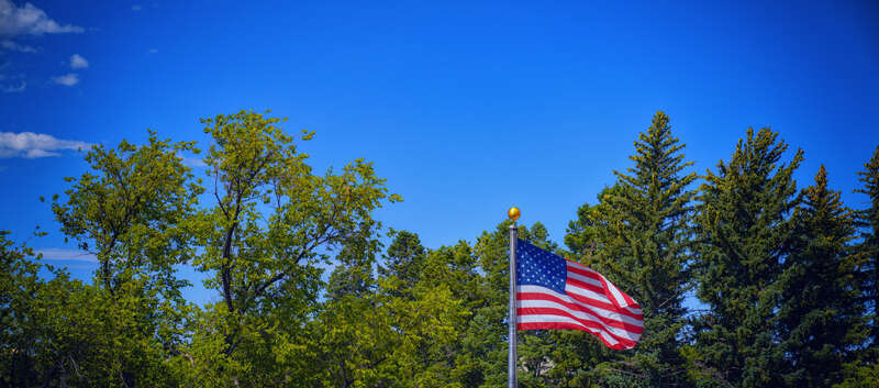 An American flag waving in the wind outside the Wyoming State Capitol in Cheyenne, Wyoming.