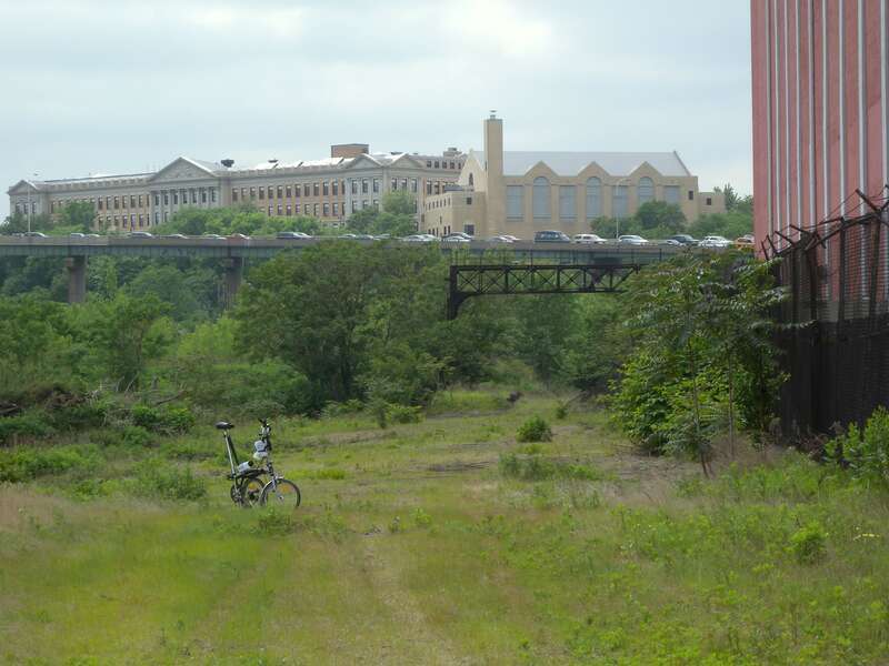 Looking west along main line.  I-78 ramp to Holland Tunnel, and Dickinson High School, are in background.