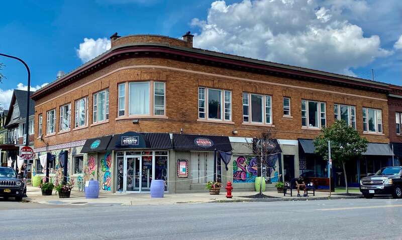 The commercial building at 1000-1004 Elmwood Avenue (corner Potomac Avenue) in Buffalo, New York, as seen in August 2022. Built in 1909 by construction contractor George N. Mead, this two-story brick structure is an example of a common architectural