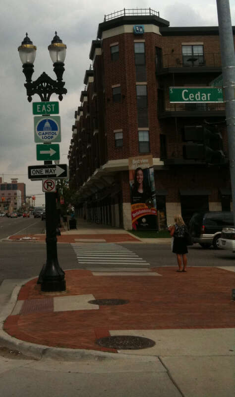 A reassurance marker for the Capitol Loop at the corner of Michigan Avenue and Cedar Street in Lansing, Michigan