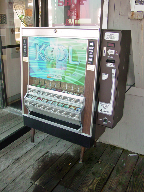 Cigarette vending machine at the Virginia Beach Fishing Pier in Virginia Beach, Virginia.  This machine was still actively being maintained at the time that this photo was taken, judging by the then-current advertisement in the machine's front