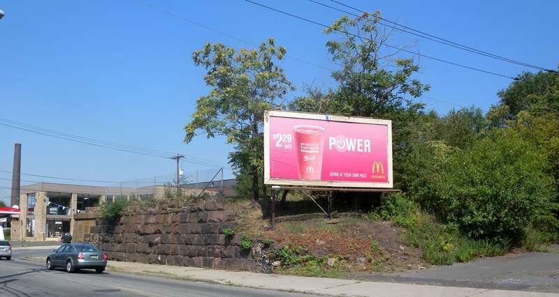 Looking northeast across Passaic Avenue at viaduct of E-L on a sunny midday in East Newark.