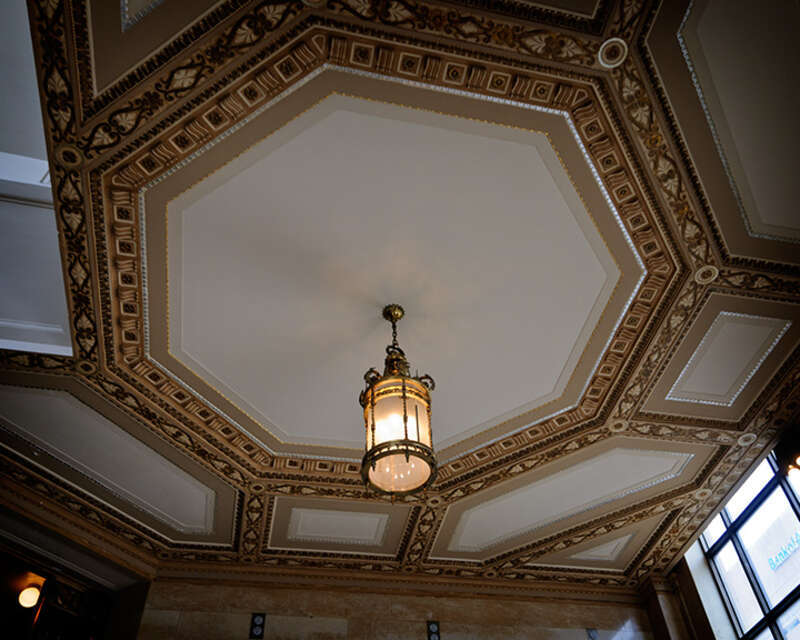 Ornate ceiling above an equally ornate staircase in a Galveston bank building