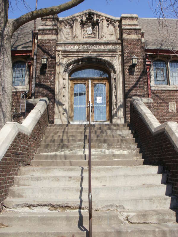 Detail of the entrance on the southeast face of the NRHP-listed Lincoln Branch Library in Duluth, Minnesota. Above the door is written &quot;Lincoln Branch Library.&quot;
