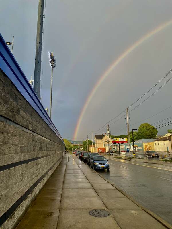 The brightest rainbow I've seen in quite some time hangs over Henry Street in Binghamton, New York, as seen outside Mirabito Stadium after the official announcement that the Rumble Ponies' July 23, 2022 game against the Hartford Yard Goats was called