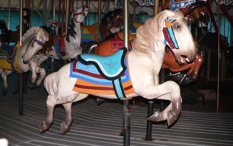 Detail of carousel in Ross Park in Binghamton, New York.  The carousel is roofed but open on the sides; however, it was closed for the winter and the sides covered with blue tarps, precluding a photo of the entire thing.