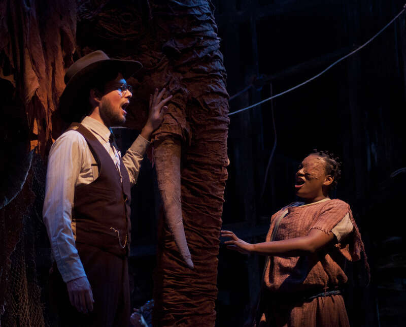 Andy Pickerill, as Wallace, and Lakecia Harris, as Pearly, pet the elephant. DN PHOTO RAFAELA ELY