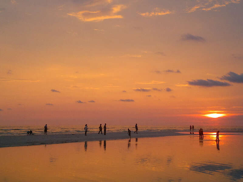 Tidepool and people at sunset, Honeymoon Island State Park, Florida