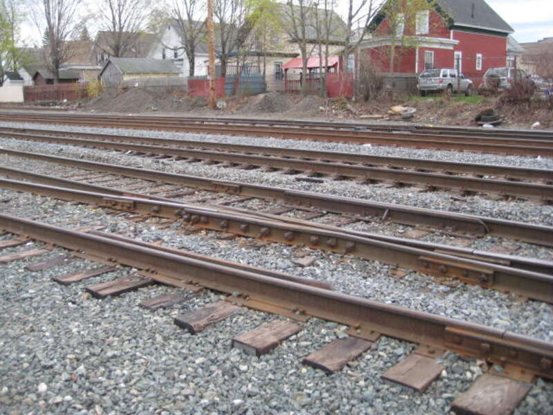 Picture inside the Lawrence yard's left (southeast) side looking towards the mainlines and the x-over with new switch motor and mechanism. Lawrence yard @ Andover St. at the North end of MBTAs Lawrence, MA yard .near Broadway. 
The two centered
