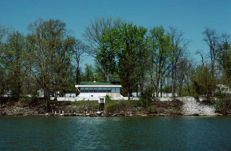 Looking ~WNW from Ohio River toward Indiana bank.
Photo 9 of 25-photo series of Ohio River mile 596 (right descending bank), taken from boat moving upstream (left to right).
.
Houses on South Front Street, Utica, Indiana.
.
Ohio River mile 596 (right