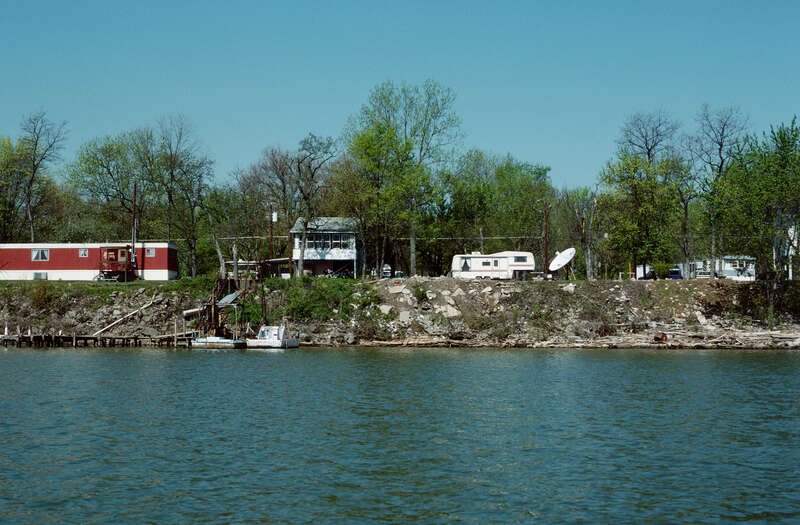 Looking ~WNW from Ohio River toward Indiana bank.
Photo 12 of 25-photo series of Ohio River mile 596 (right descending bank), taken from boat moving upstream (left to right).
.
Houses on South Front Street, Utica, Indiana.
.
Ohio River mile 596