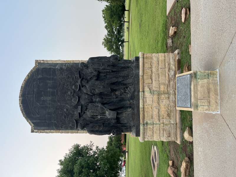 The relief sculpture is entitled Auction of Lawton Townsite Lots 6 August 1901 and serves as a centerpiece between McMahon Memorial Auditorium and the Museum of the Great Plains in Lawton, Oklahoma.