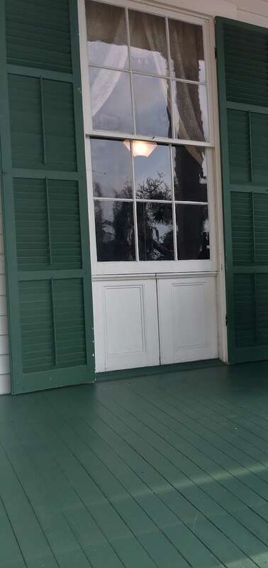A close up of the windows of the Bronson-Mulholland House.  Most of the windows are jib windows;  note the doors below the glass that could be opened to fully extended the window to the floor.