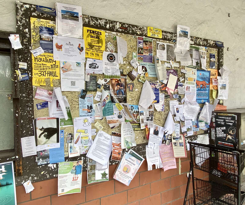 a bulletin with many flyers at Woodside, California (outside Roberts Market)