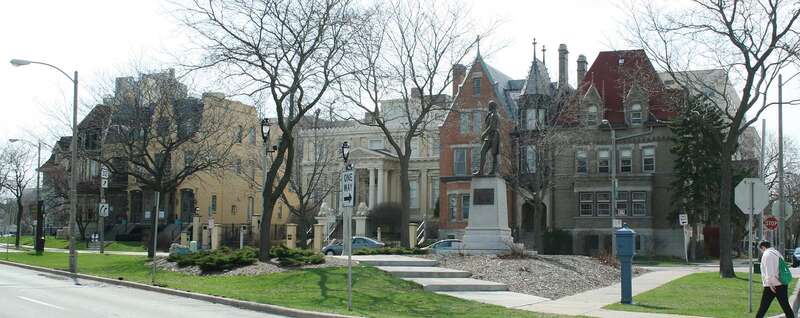 Statue of Scottish poet Robert Burns, on the south end of Burns Commons Park, Milwaukee, Wisconsin, situated in front of the eastern side of First Ward Triangle Historic District, National Registered Historic Place.
