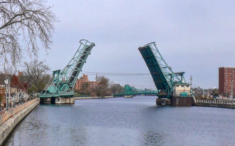 The Cass Street Bridge, across the Des Plaines River in Joliet, Illinois, U.S., with its Scherzer Rolling Lift bascule draw span opened (for river traffic or testing).  The photo was taken from the Jefferson Street Bridge, looking north. The Jackson