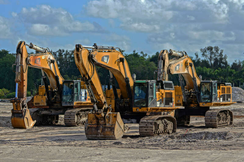 Caterpillar and John Deere Heavy Construction Equipment in a Davie Field under a cloudy sky. A drive-by opportunity I turned around for. Part of my New Years' Resolution not to take it for granted that tomorrow will be another day to stop and capture