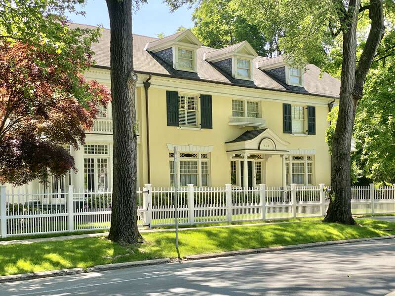 Built in 1880 and later renovated heavily in the early 20th Century, this Renaissance Revival-style house features a stucco-clad exterior, side gable roof, a cornice with dentils eighteen-over-one, twelve-over-one, eight-over-one, and six-over-one