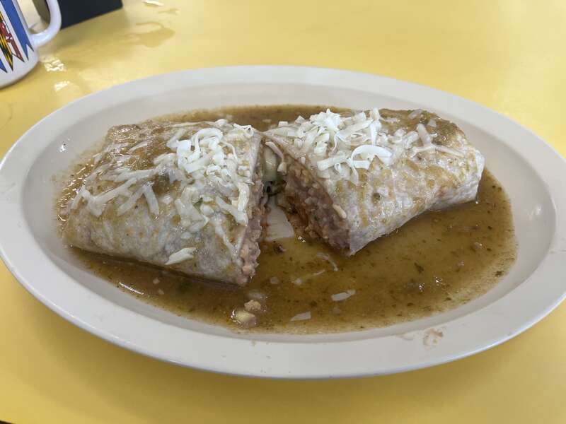 This is a Chile Rellenos Burrito from El Taco de Mexico which has been ordered &quot;smothered&quot;, in which the burrito has green chili poured on top of it.