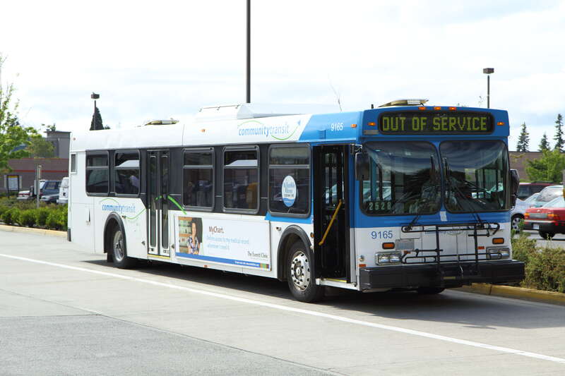Community Transit 9165, a 1999 New Flyer D40LF, at a bus layover at the Aurora Village Transit Center in Shoreline.