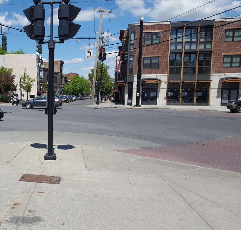 This point is where Lark Street and Madison Avenue in Albany, New York's street grid meet, Delaware Avenue then bisects the southeast corner. Behind the camera and the Capital District Tourism Gnome is Dana Park wedged between Delaware and Lark, with