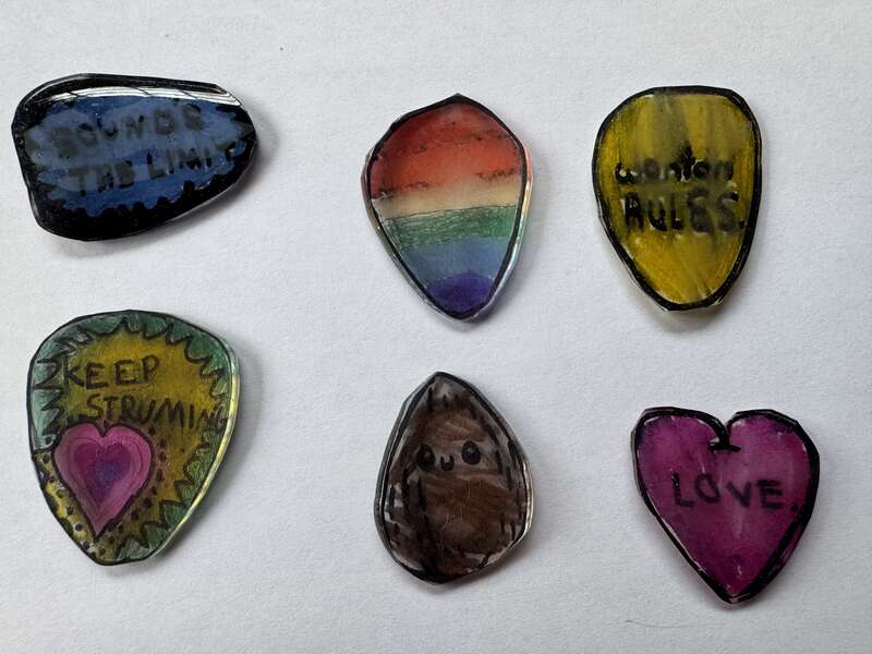 Set of six custom guitar picks made using Shrinky Dinks