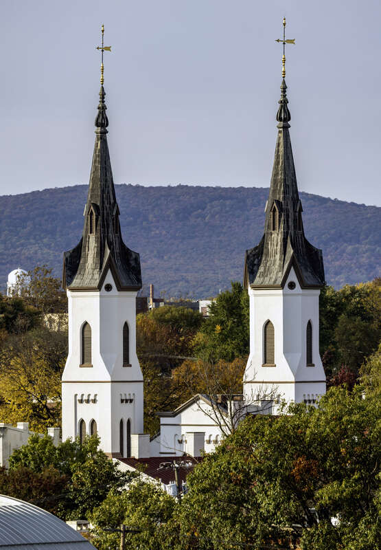 The spires of Evangelical Lutheran Church, with Catoctin Mountain behind, Frederick, Maryland, USA