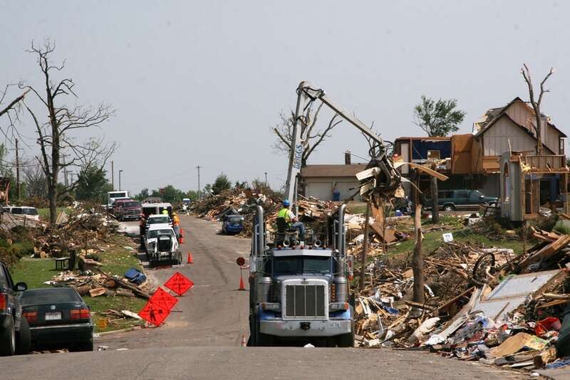 Contracted haul trucks work to remove millions of cubic yards of debris which line the streets of Joplin, Mo., after the EF5 tornado touched down on May 22. The Corps of Engineers was tasked with the debris removal and disposal mission by FEMA. 
U.S.