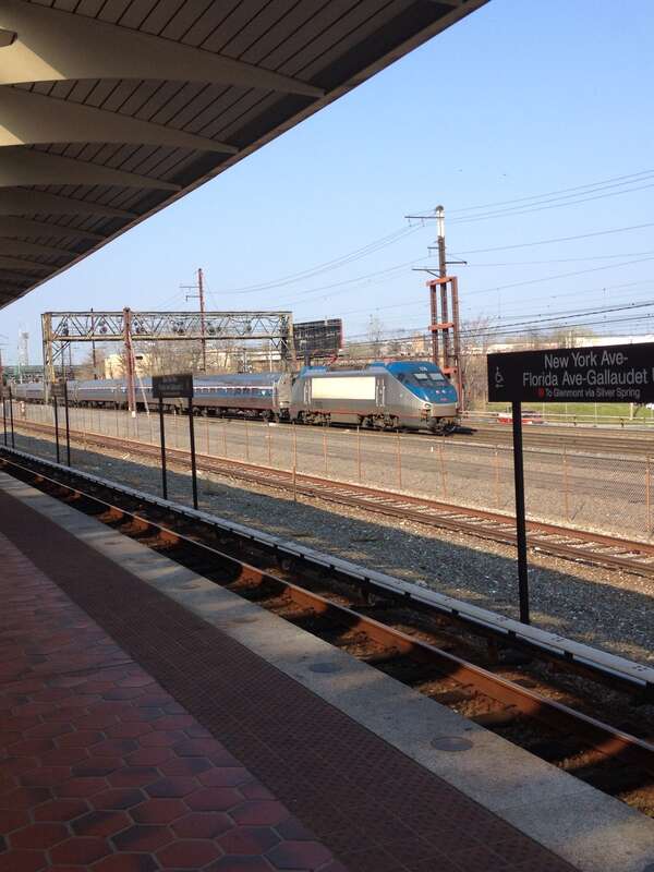 A Northeast Regional train heading southbound to Union Station viewed from the NoMa - Gallaudet University station of the Washington Metro