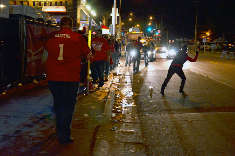 Scene in front of a bar near Badger Stadiyum on Regent Street in Madison, Wisconsin with a night football game in progress