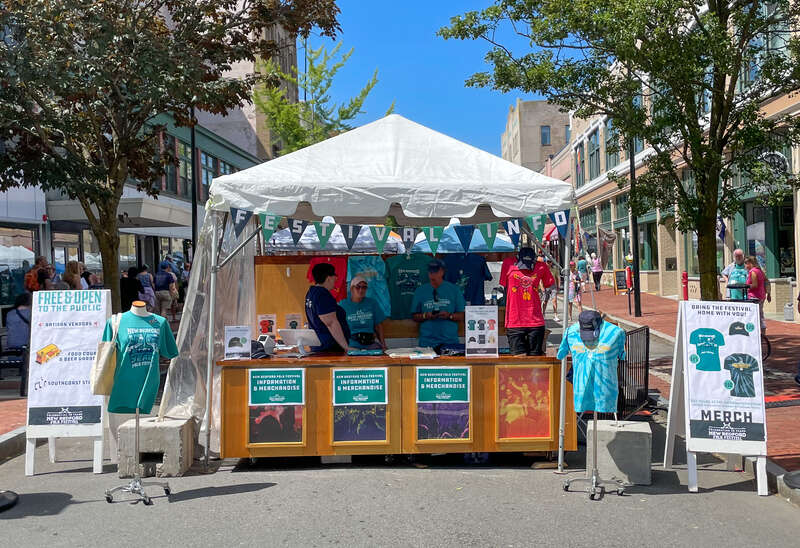 Merchandise table at the New Bedford Folk Festival 2022