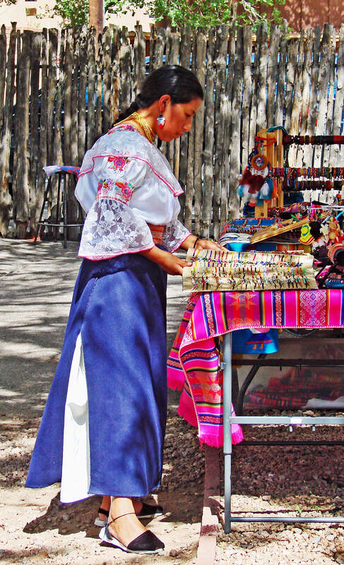 (1 in a multiple picture album)
This lady was working at her craft in Santa Fe, NM.  She looked so attractive to me, both her facial features and her dress.  Note the fine lace on her blouse.  The native tribe here display the Spanish blood in their