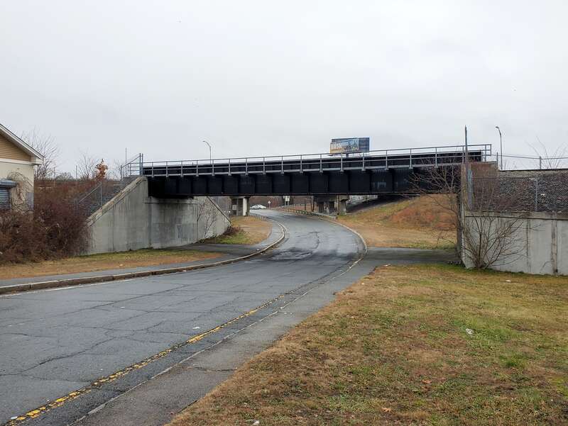 Bridge carrying the New Bedford Secondary over a Route 18 off-ramp in New Bedford, seen in December 2023