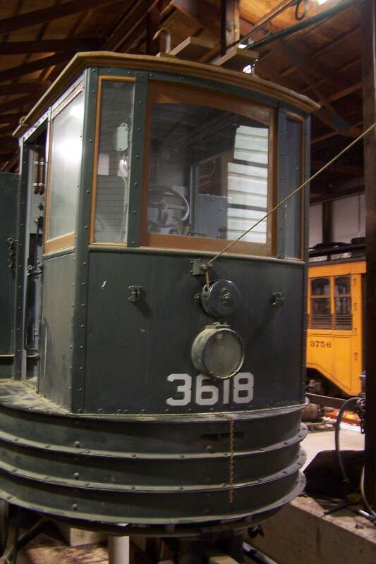 A work car under repair in the shop at the PA Trolley Museum in Washington, PA.  This car will assist in reballasting the &quot;right of way&quot; at the museum.