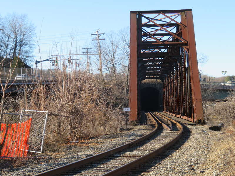 Shetucket River railroad bridge in December 2018. The east portal of the short Laurel Hill Tunnel is visible through the bridge.