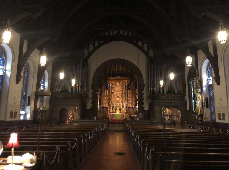 A view of the interior of St. Clement's Church in Philadelphia, showing the main aisle and altar, viewed from the entrance.