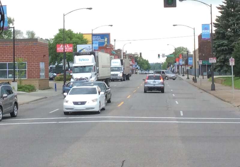 Two semi trucks in service of the distribution corporation Sysco. On Rice Street in the North End of Saint Paul, Minnesota.