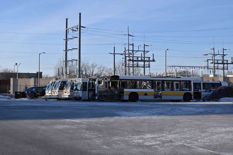 Various MBTA buses and bus shells being stored at the MBTA Everett Shops. From back to front are various RTS work buses, a New Flyer D40LF work bus, and two Neoplan AN440LF shells.