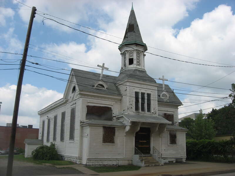 Front and eastern side of the former Welsh Congregational Church (now boarded up and abandoned, following a fire), located at 220 N. Elm Street in Youngstown, Ohio, United States.  Built in 1861, it is listed on the National Register of Historic