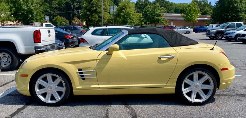 2005 Chrysler Crossfire roadster finished in yellow with black fabric top. Photographed September 2024 in Bowie, Maryland.
