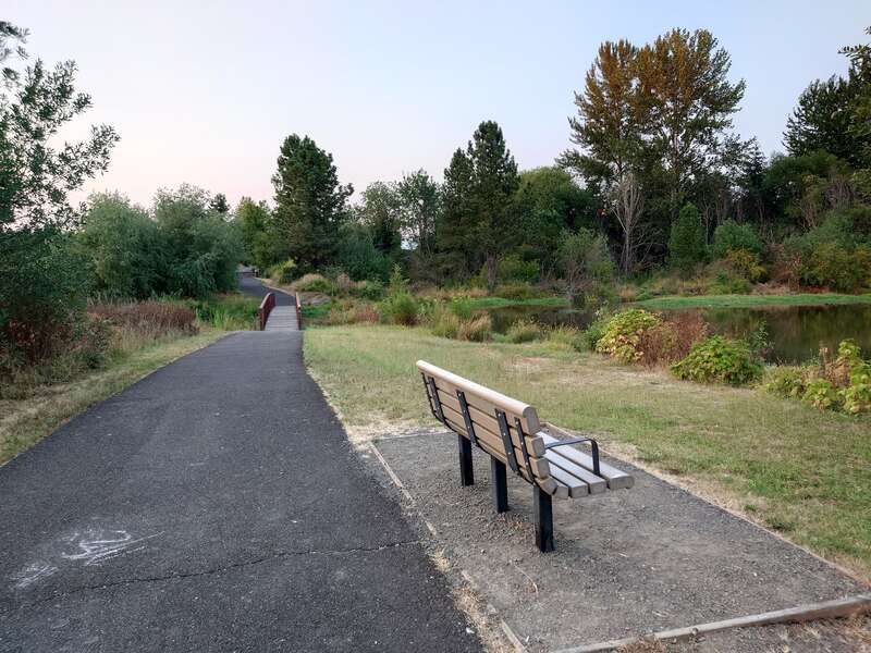 Pathway and bench in Beaverton Creek Wetlands Natural Area in Beaverton, Oregon