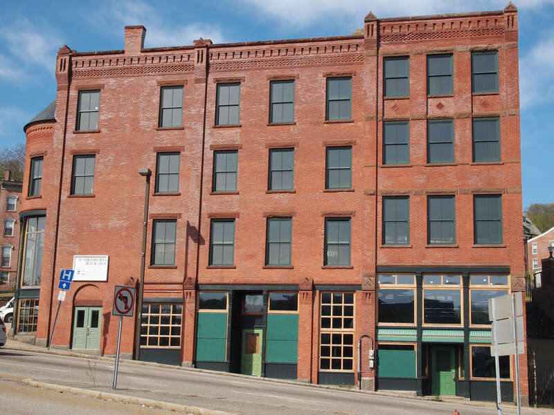 Connecticut - New London County - Norwich
National Register of Historic Places #82001007 NRIS
2011 May 01 Water St. view from Chelsea Harbor Dr. view N
edit: none

White sign says &quot;Flatiron Building Restoration&quot;. Building is currently empty.