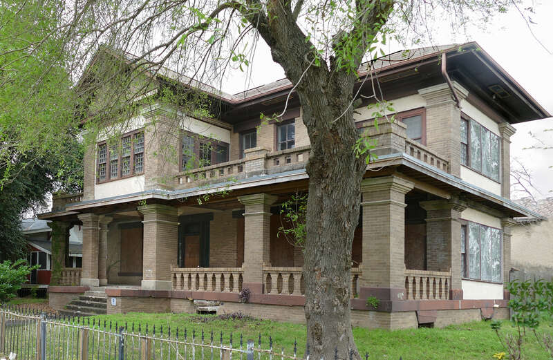 The Colonel Hugh B. and Helen Moore House (1912) is a 2 1/2-story brick hipped roof building facing south on 9th Avenue in Texas City on the western shore of Galveston Bay. The house largely follows the Prairie School style popular in the early 20th
